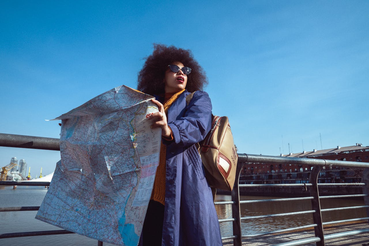 Woman with Map Standing on Bridge